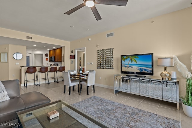 living room featuring ceiling fan and light tile patterned flooring