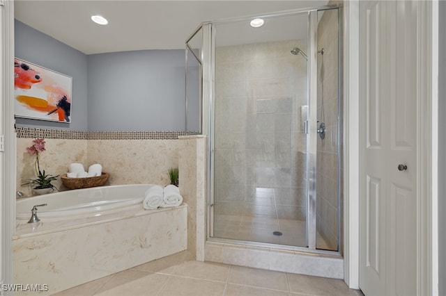 bathroom with tile patterned floors and independent shower and bath