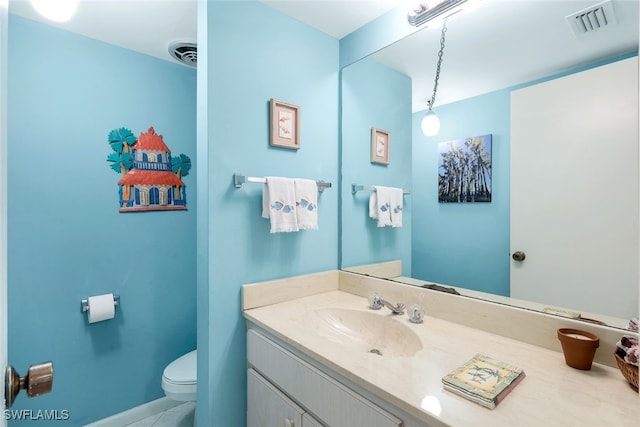 bathroom with tile patterned flooring, vanity, and toilet