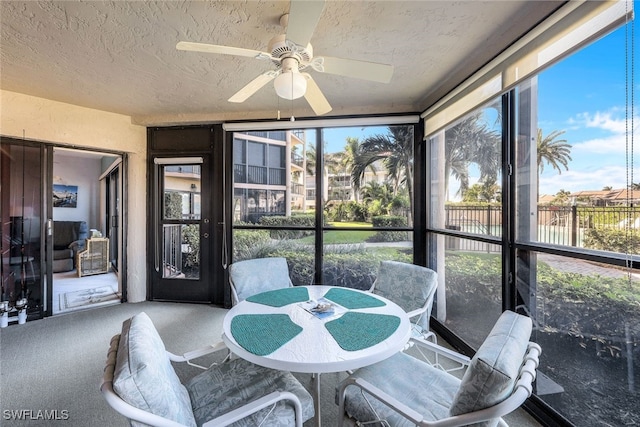 sunroom / solarium featuring ceiling fan