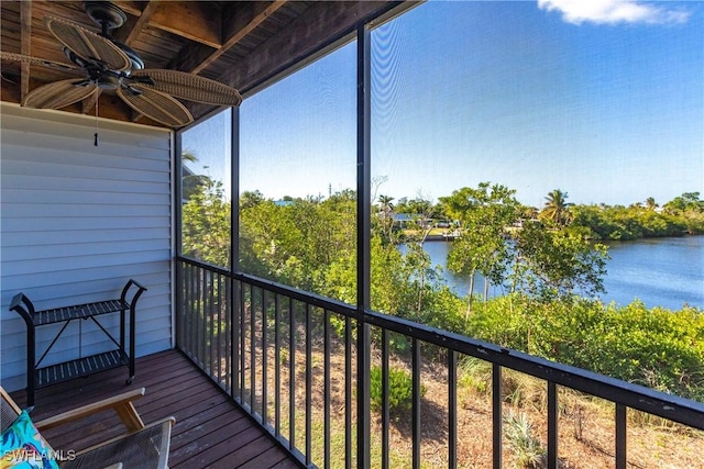 unfurnished sunroom featuring ceiling fan, a water view, and wood ceiling