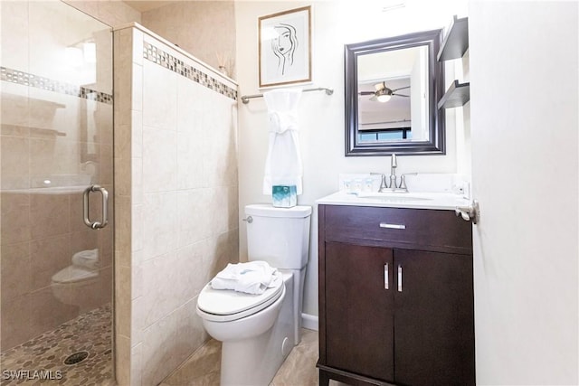 bathroom with vanity, tile patterned flooring, ceiling fan, toilet, and an enclosed shower