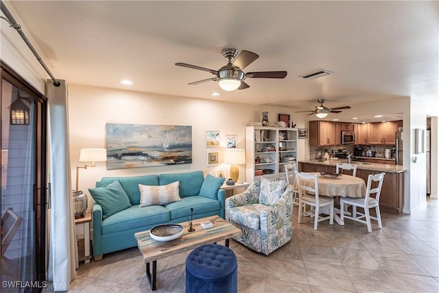 living room featuring ceiling fan and light tile patterned floors