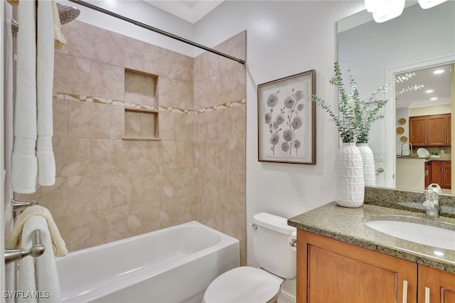 full bathroom featuring vanity, bathing tub / shower combination, toilet, and ornamental molding