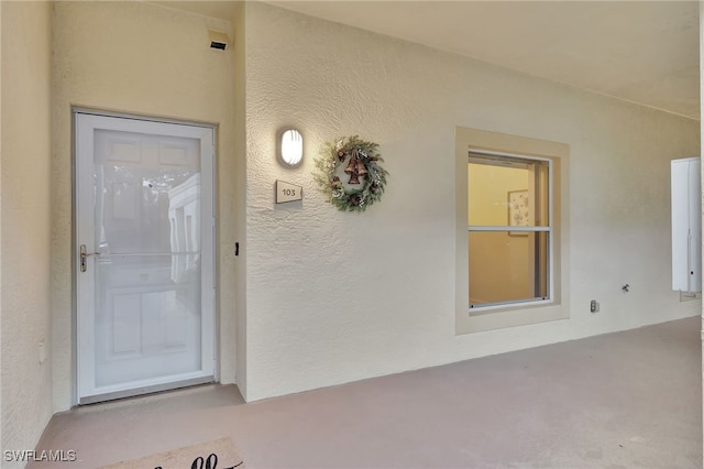 property entrance featuring stucco siding