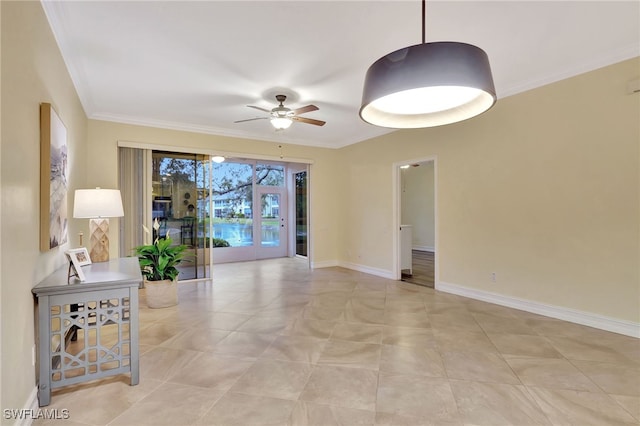 interior space featuring light tile patterned floors, baseboards, a ceiling fan, and crown molding