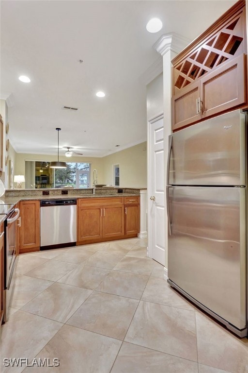 kitchen with a sink, appliances with stainless steel finishes, recessed lighting, and brown cabinetry