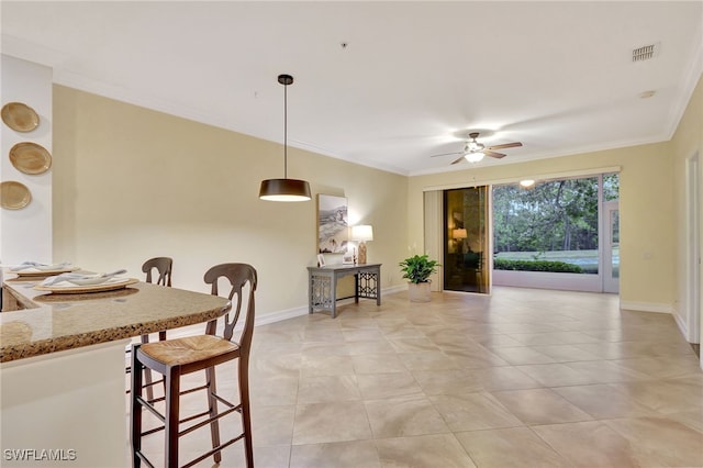 dining area with visible vents, baseboards, a ceiling fan, and crown molding