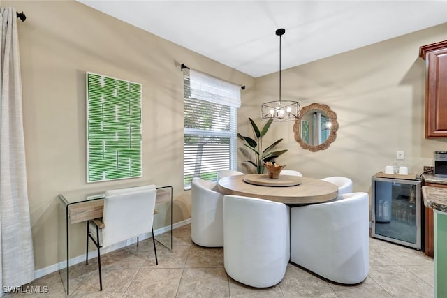 dining space with a chandelier, light tile patterned floors, and beverage cooler