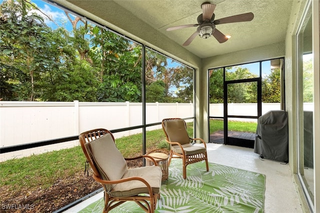 sunroom featuring ceiling fan