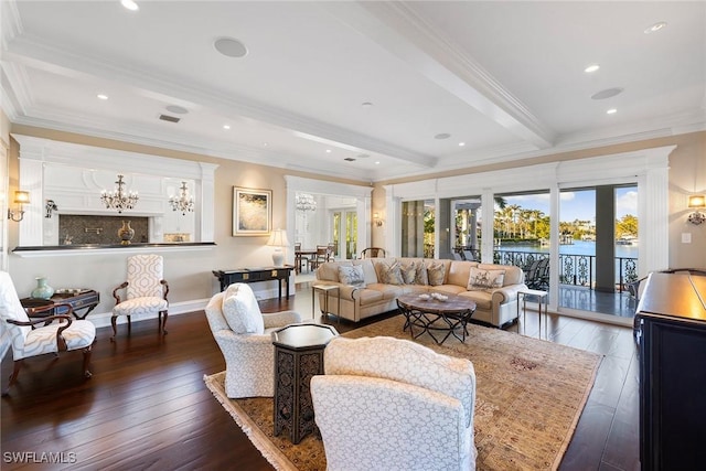 living area featuring ornamental molding, beam ceiling, hardwood / wood-style floors, and an inviting chandelier