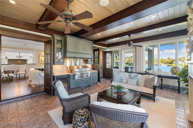 living area with wood ceiling, a water view, beam ceiling, and a ceiling fan