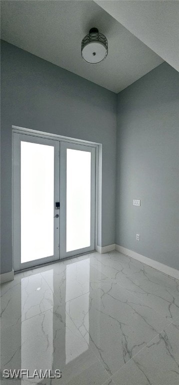 spare room with a healthy amount of sunlight, a textured ceiling, and french doors