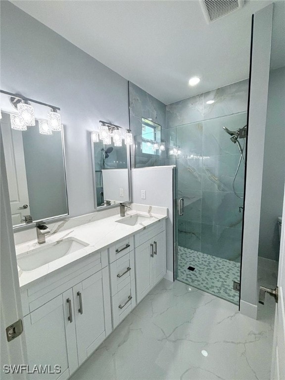 bathroom with vanity and a shower with shower door