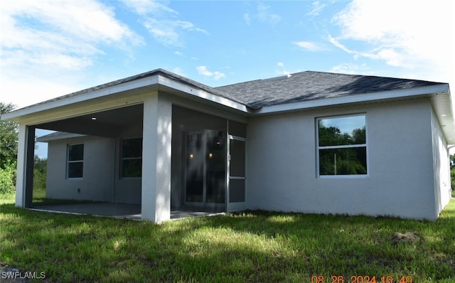 rear view of house with a patio area and a yard