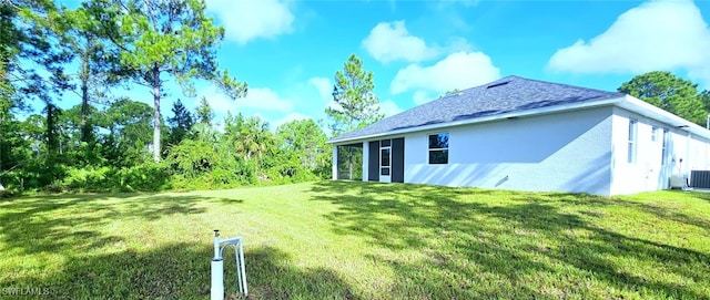 back of property with a lawn