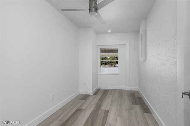 spare room with light hardwood / wood-style floors and ceiling fan