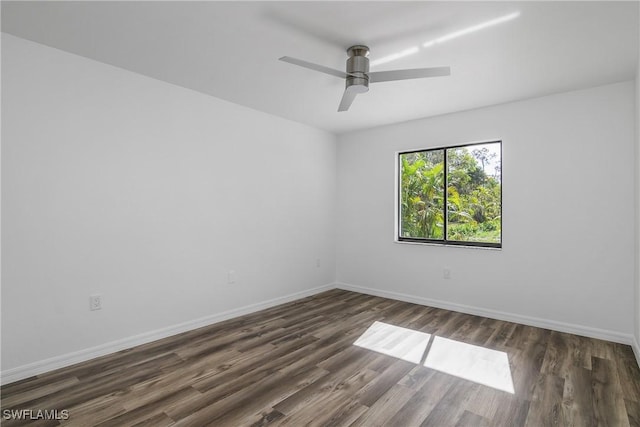 unfurnished room featuring ceiling fan and dark wood-type flooring