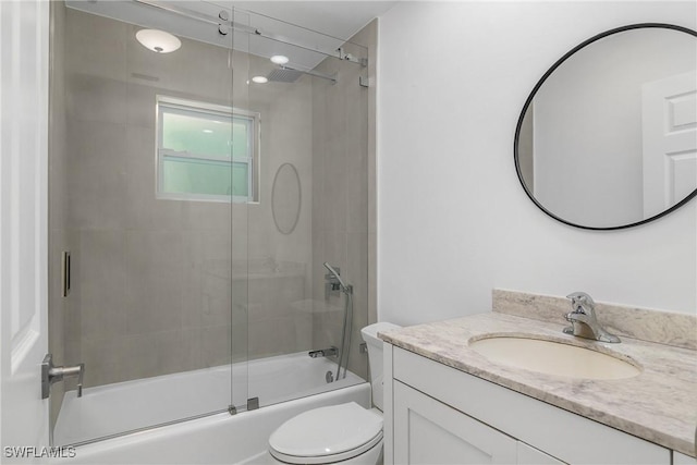 full bathroom with vanity, toilet, and enclosed tub / shower combo