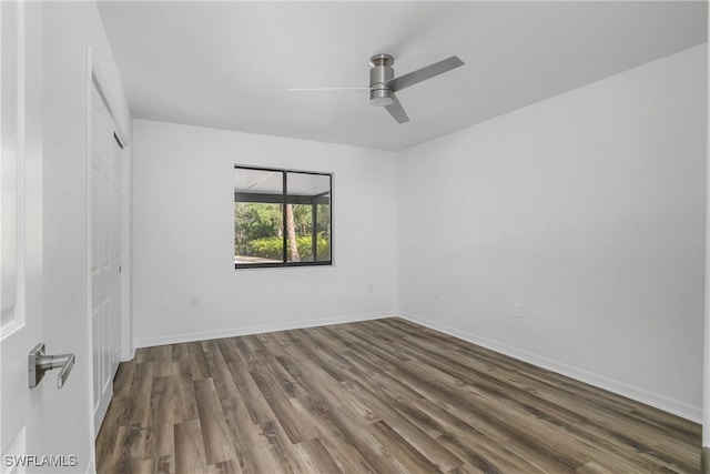 unfurnished room featuring dark hardwood / wood-style floors and ceiling fan