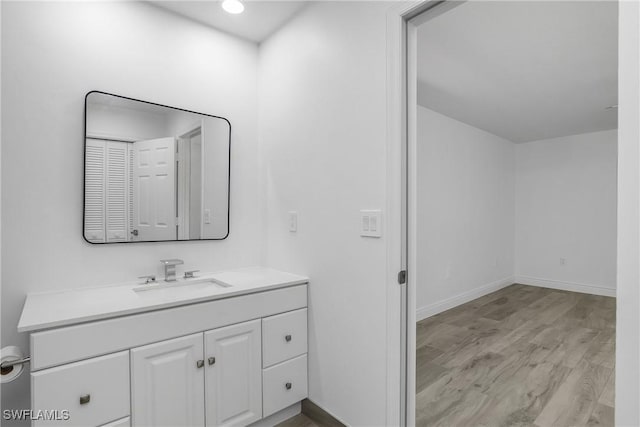 bathroom with wood-type flooring and vanity