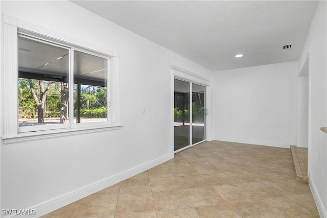 empty room with light tile patterned flooring