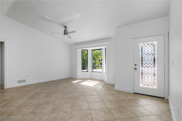 tiled entryway with ceiling fan and lofted ceiling