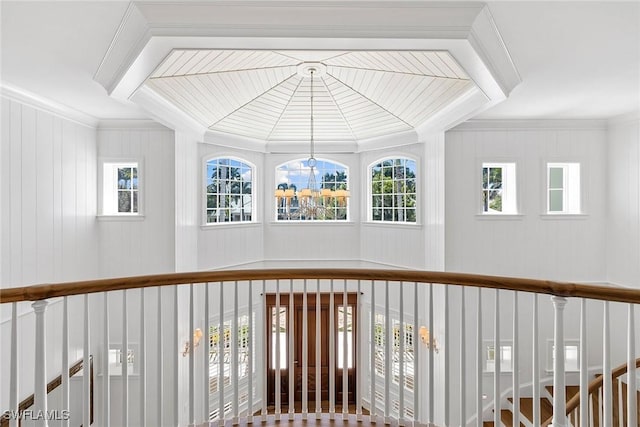 hallway featuring a chandelier and ornamental molding