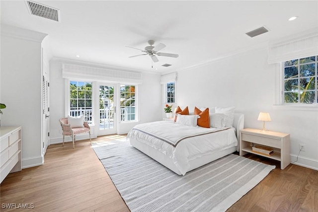 bedroom with ceiling fan, light wood-type flooring, crown molding, and access to outside