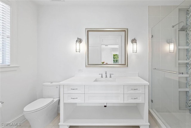 bathroom featuring a shower with door, vanity, a healthy amount of sunlight, and toilet