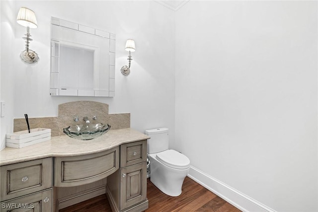 bathroom featuring hardwood / wood-style floors, toilet, and sink