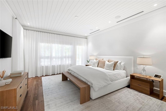 bedroom featuring wood-type flooring, crown molding, and wood ceiling