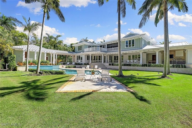 back of property featuring a patio and a lawn