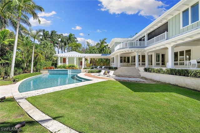 view of pool featuring a lawn and a patio