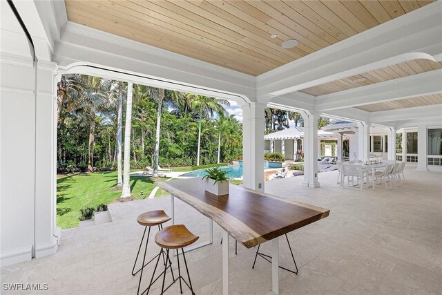 sunroom / solarium with ornate columns and wood ceiling