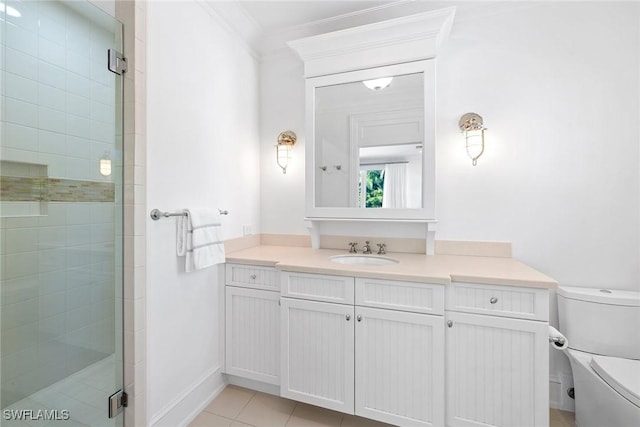 bathroom featuring vanity, a shower with door, crown molding, tile patterned flooring, and toilet