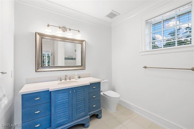 bathroom with tile patterned floors, vanity, toilet, and crown molding