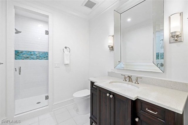 bathroom featuring tile patterned floors, crown molding, toilet, vanity, and a shower with shower door