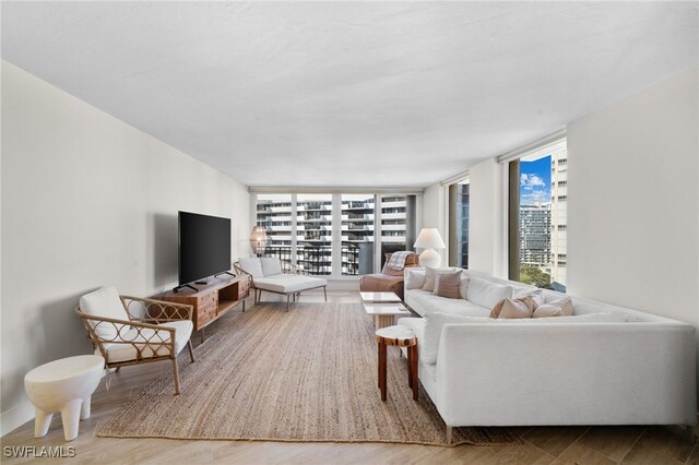 living room featuring floor to ceiling windows and hardwood / wood-style flooring