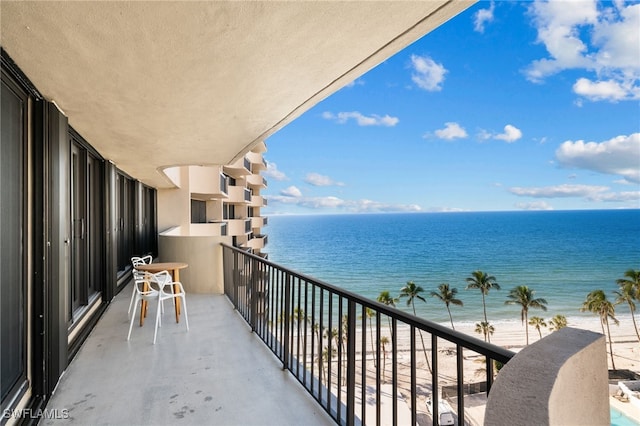 balcony with a view of the beach and a water view