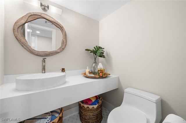 bathroom featuring sink and toilet