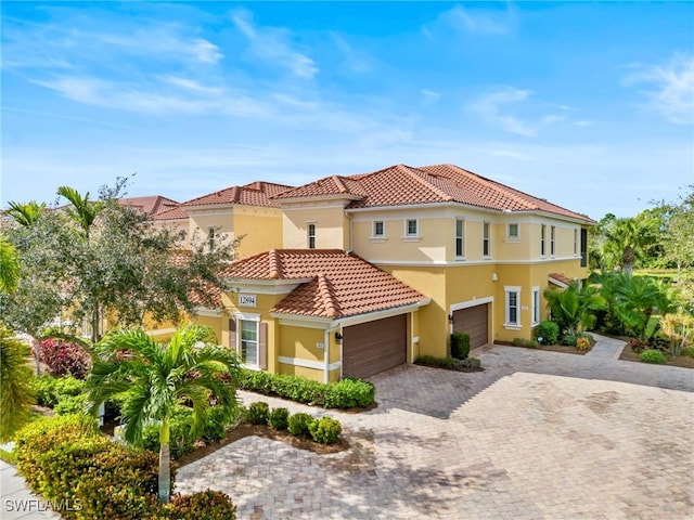 mediterranean / spanish-style house with a garage