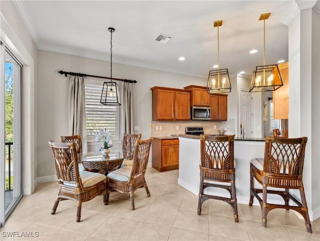 kitchen with decorative light fixtures, plenty of natural light, and appliances with stainless steel finishes