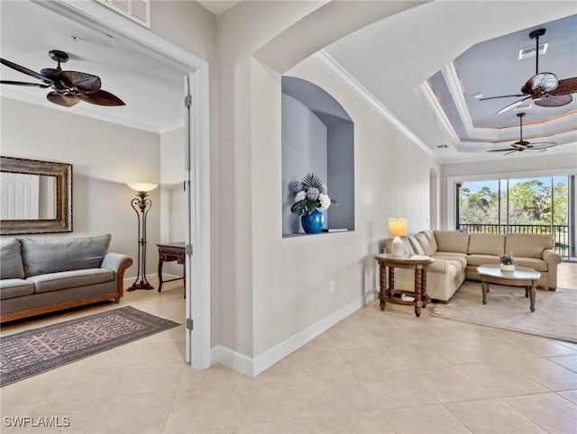 tiled living room featuring a raised ceiling and crown molding