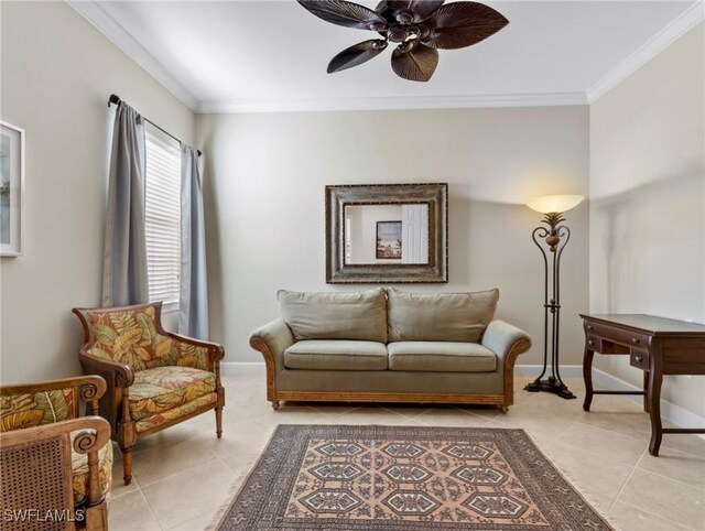 living area with crown molding, ceiling fan, and light tile patterned floors