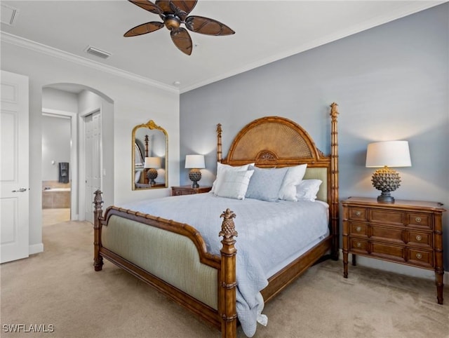 carpeted bedroom featuring connected bathroom, a closet, ceiling fan, and ornamental molding