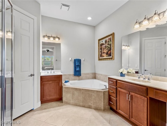 bathroom featuring tile patterned flooring, vanity, ceiling fan, and plus walk in shower