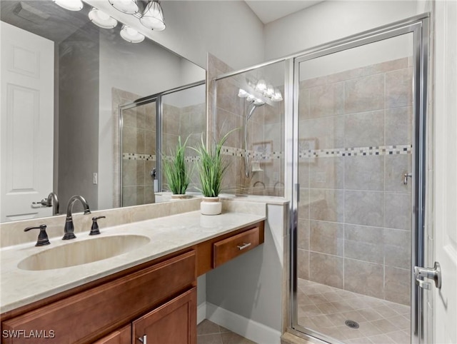 bathroom featuring tile patterned flooring, vanity, and a shower with shower door