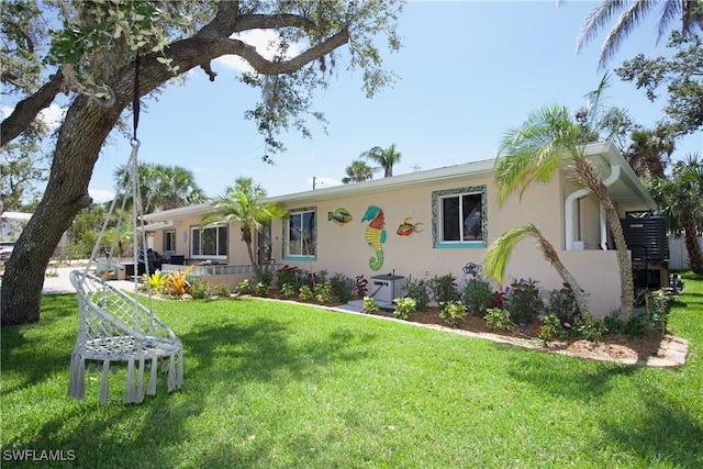 single story home featuring a front lawn and stucco siding