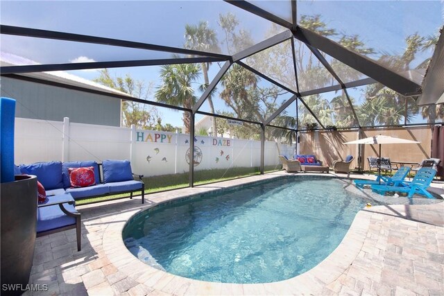 view of swimming pool with glass enclosure, a patio area, and an outdoor hangout area